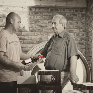 two winemakers in brick cellar