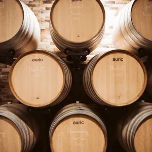 stacked oak barrels against brick