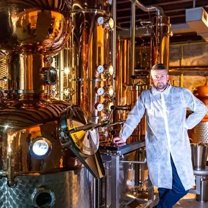 distiller beside copper pot stills
